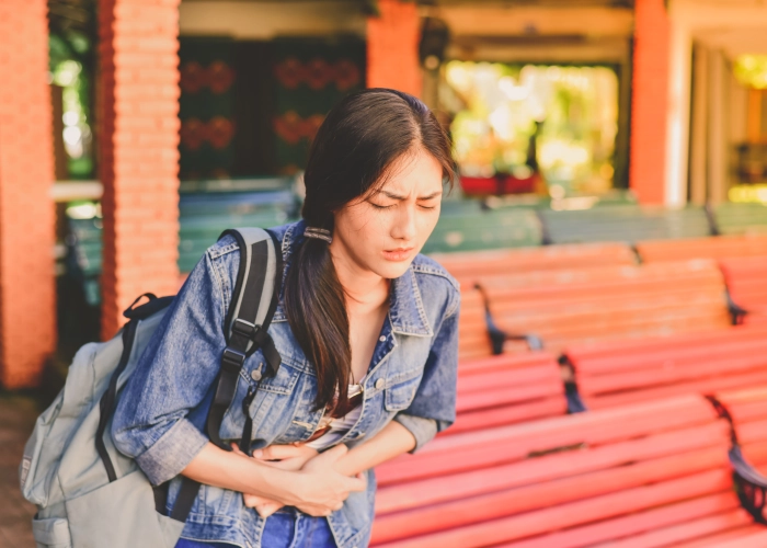 young-woman-looking-away-while-standing-outdoors